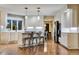 Gourmet kitchen with white cabinetry, stainless steel appliances, and a center island with seating at 9980 Newton Ct, Westminster, CO 80031