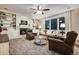 Cozy living room featuring a fireplace, built-in shelves, plush seating, and a ceiling fan at 9980 Newton Ct, Westminster, CO 80031