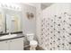 Cozy bathroom featuring a floral shower curtain, vanity with a sink, and wall decor at 4222 S Blackhawk Cir # 6C, Aurora, CO 80014