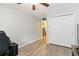 Bedroom with light-colored walls, closet, ceiling fan and door leading out of the room at 4222 S Blackhawk Cir # 6C, Aurora, CO 80014