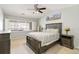 Bright bedroom features a large bed, ceiling fan, and ample natural light from shuttered window at 4222 S Blackhawk Cir # 6C, Aurora, CO 80014