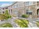 Inviting two-story condo with manicured landscaping, stone facade, and charming architectural details at 4222 S Blackhawk Cir # 6C, Aurora, CO 80014