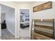 Hallway with wood-look floors, view into bedroom with ceiling fan, and wall art at 4222 S Blackhawk Cir # 6C, Aurora, CO 80014
