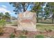 Stone sign for Avalon community set among green lawns and trees, creating a welcoming atmosphere at 4222 S Blackhawk Cir # 6C, Aurora, CO 80014
