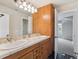 Bathroom featuring double sinks, floral tile accents, and black tile flooring at 902 Anaconda Ct, Castle Rock, CO 80108