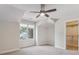 Bright bedroom with a ceiling fan, neutral paint, large window and walk in closet at 902 Anaconda Ct, Castle Rock, CO 80108