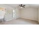 Bedroom with light carpet, ceiling fan, and an attached bathroom at 902 Anaconda Ct, Castle Rock, CO 80108