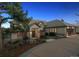 Stately home at dusk featuring manicured landscaping and a circular driveway at 902 Anaconda Ct, Castle Rock, CO 80108