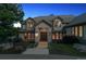 Traditional home exterior featuring a stone walkway and manicured landscaping at 902 Anaconda Ct, Castle Rock, CO 80108