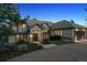 Elegant stucco home with a tile roof, mature landscaping, and attached garage at 902 Anaconda Ct, Castle Rock, CO 80108