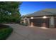 Home featuring a three car garage, large driveway and mature landscaping at 902 Anaconda Ct, Castle Rock, CO 80108