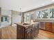 Open concept kitchen with a dark wood island, granite counters, and eat in breakfast area with natural light at 902 Anaconda Ct, Castle Rock, CO 80108