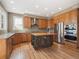 Charming kitchen with wooden cabinets, stainless steel appliances, granite counters, and a functional island at 902 Anaconda Ct, Castle Rock, CO 80108