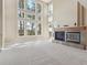 Bright living room with a fireplace, carpet flooring, and large windows at 902 Anaconda Ct, Castle Rock, CO 80108