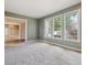 Spacious living room with lots of natural light, neutral carpet, and muted green walls at 902 Anaconda Ct, Castle Rock, CO 80108