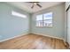 Light-filled bedroom with hardwood floors and a large window offering neighborhood views at 1998 Foxtail Ln # B, Lafayette, CO 80026