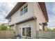 Exterior angle view shows a modern house with a small patio and fenced backyard at 1998 Foxtail Ln # B, Lafayette, CO 80026