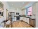 Modern kitchen with stainless steel appliances, white cabinets, and sleek countertops, bathed in natural light at 1998 Foxtail Ln # B, Lafayette, CO 80026