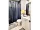 Bathroom featuring a shower with dark shower curtain, white vanity and dark framed mirror at 20308 E 48Th Dr, Denver, CO 80249