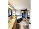 This bathroom features a walk-in shower, granite countertop vanity, and soaking tub at 20308 E 48Th Dr, Denver, CO 80249
