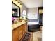 Bathroom with granite countertops, dark wood cabinets, a jacuzzi tub, and walk-in shower at 20308 E 48Th Dr, Denver, CO 80249