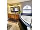 Bright bathroom with a soaking tub under arched window and granite countertop vanity at 20308 E 48Th Dr, Denver, CO 80249