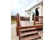 Exterior view of a wood deck with stairs and sliding glass door to the home at 20308 E 48Th Dr, Denver, CO 80249