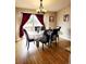 Well lit dining area featuring hardwood floors, stylish chandelier, and sliding door at 20308 E 48Th Dr, Denver, CO 80249
