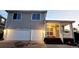 Two-story home featuring a two-car garage and covered front porch with freshly painted doors at 20308 E 48Th Dr, Denver, CO 80249