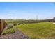 Large backyard with lush green grass, rock border, wooden fence, and beautiful landscaping at 242 S Old Hammer Ct, Aurora, CO 80018