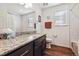 Bathroom features granite counters, wood cabinets, and shower-tub combination at 242 S Old Hammer Ct, Aurora, CO 80018