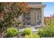 Front entrance of home featuring manicured landscaping and stone accents at 242 S Old Hammer Ct, Aurora, CO 80018