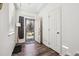 Bright entryway with wood-look flooring, modern lighting, and view to exterior at 242 S Old Hammer Ct, Aurora, CO 80018