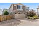Beautiful two-story home with a stone facade and brick driveway at 242 S Old Hammer Ct, Aurora, CO 80018