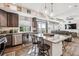 Open-concept kitchen with stainless steel appliances and granite countertops at 242 S Old Hammer Ct, Aurora, CO 80018