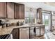 Kitchen features granite countertops, stainless steel appliances, and backyard access at 242 S Old Hammer Ct, Aurora, CO 80018