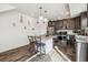 Bright kitchen features a granite-topped island with seating and stainless steel appliances at 242 S Old Hammer Ct, Aurora, CO 80018