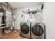 Functional laundry room features modern Whirlpool washer and dryer set with convenient storage shelves above at 242 S Old Hammer Ct, Aurora, CO 80018