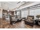 Open-concept living room featuring hardwood floors, ceiling fan, and comfortable leather seating at 242 S Old Hammer Ct, Aurora, CO 80018