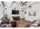 Spacious living room featuring hardwood floors, a ceiling fan, and a modern media center at 242 S Old Hammer Ct, Aurora, CO 80018