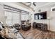 Comfortable living room with a fireplace, wooden floors, and large windows at 242 S Old Hammer Ct, Aurora, CO 80018