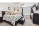 Bright bedroom with a ceiling fan, large bed, and a dresser at 242 S Old Hammer Ct, Aurora, CO 80018