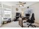 Office space features a large window, ceiling fan, and multiple workstations at 242 S Old Hammer Ct, Aurora, CO 80018