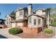 Tan three-story townhome with brick accents and landscaping at 5202 Union Ct # 2, Arvada, CO 80002