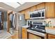 Stainless steel appliances and wood cabinets in this kitchen at 5202 Union Ct # 2, Arvada, CO 80002