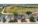 Aerial view showcasing a residential home with well-manicured landscaping and nearby open fields at 3691 Bucknell Dr, Highlands Ranch, CO 80129