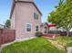 Exterior view of the house and backyard, featuring a well-maintained lawn and a deck at 3691 Bucknell Dr, Highlands Ranch, CO 80129