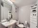 Bathroom features a pedestal sink, toilet, and a storage cabinet with decorative items at 3691 Bucknell Dr, Highlands Ranch, CO 80129