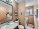 Functional bathroom with a vanity, toilet, and convenient laundry area including a washer and dryer at 3691 Bucknell Dr, Highlands Ranch, CO 80129