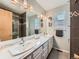 Modern bathroom with a large double sink vanity, ample counter space, and a separate shower area at 3691 Bucknell Dr, Highlands Ranch, CO 80129